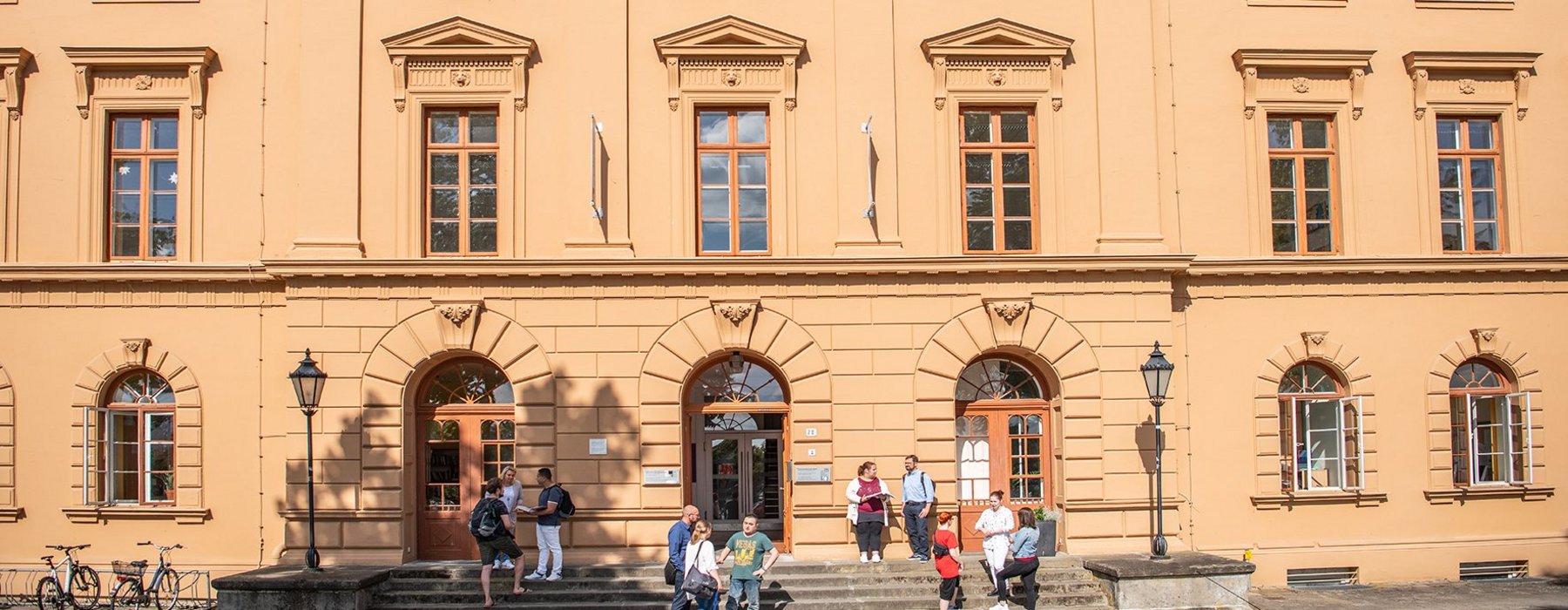 Die Evangelische Pflegeschule von außen. Auf den Treppen der Schule sitzen ein paar Schüller andere stehen und unterhalten sich oder sind auf dem Weg ins Gebäude.